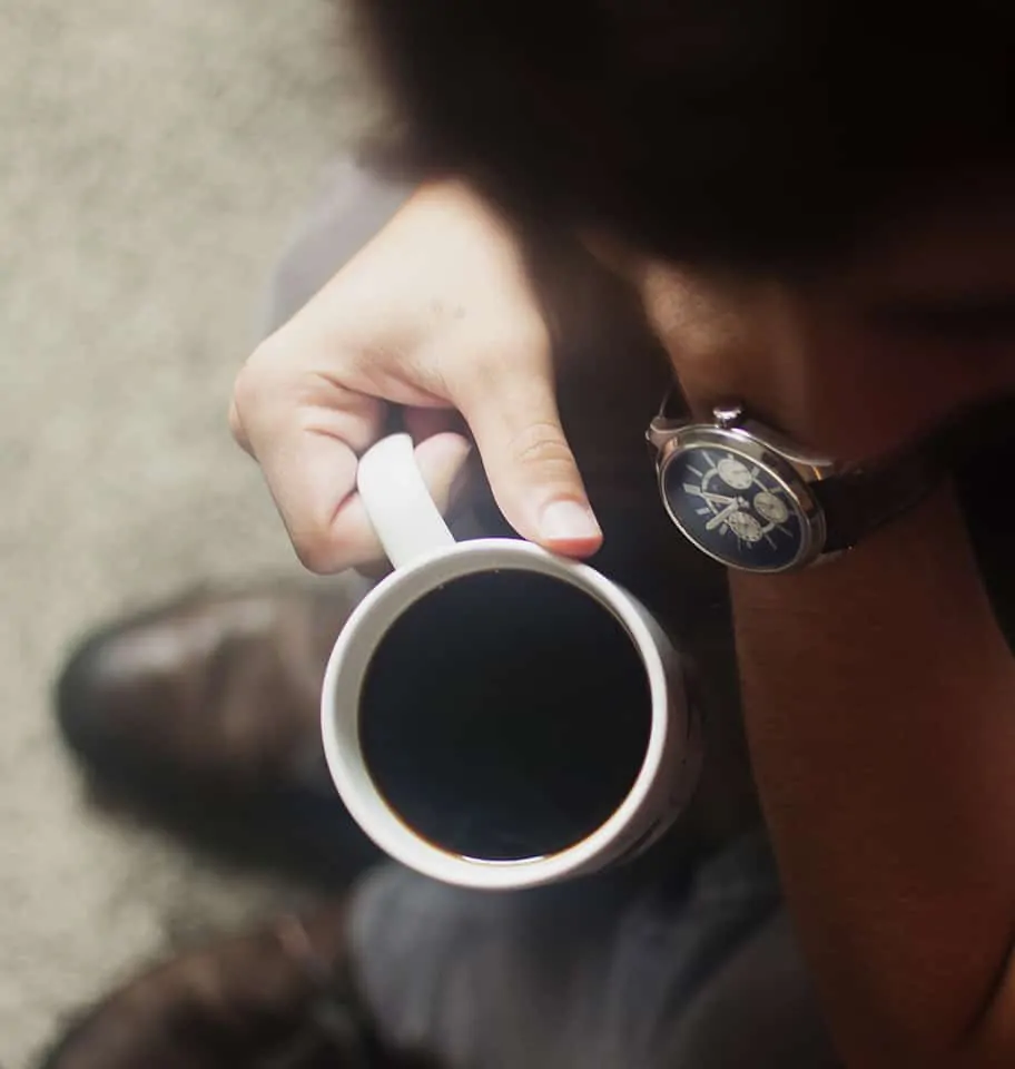 Man waiting for at fertility check with a cup of coffe