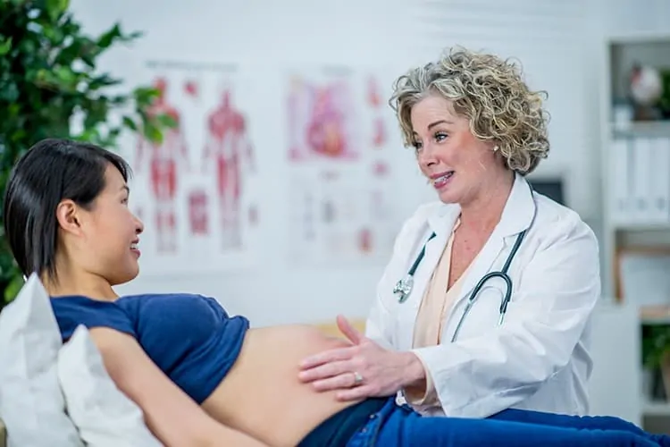 A woman seeing the fertility doctor during her pregnancy