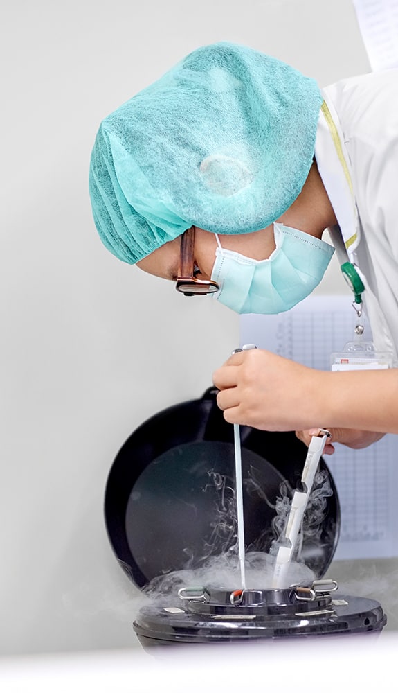 A laboratory scientist freezing eggs or embryos