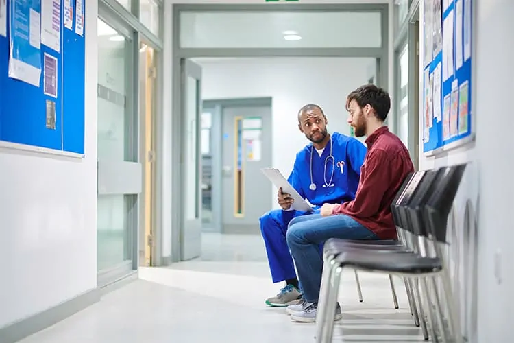 A doctor talking to a worried man with Klinefelter syndrome