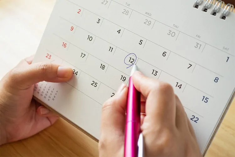 Woman with a calendar marking the first day of her fertile window