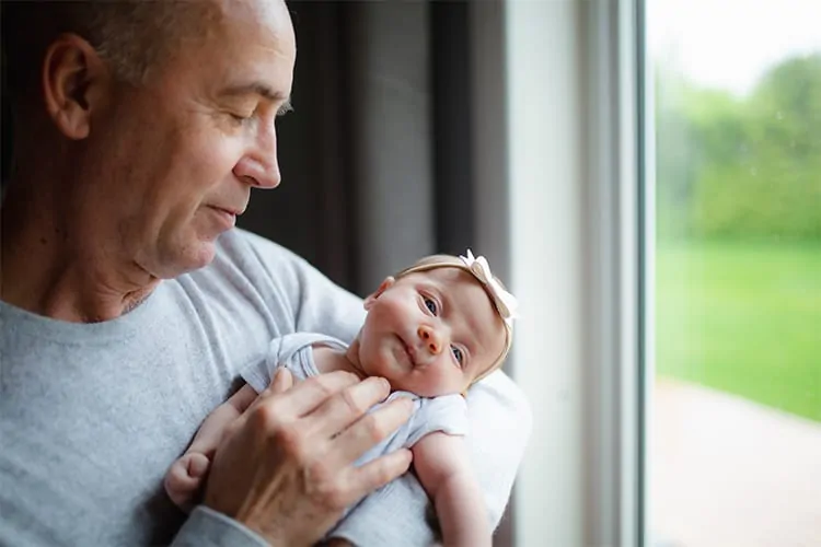 Middle-aged man with a newborn