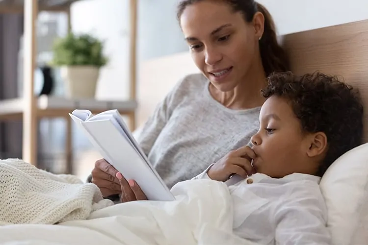 An American mother reading a book to her child about adoption