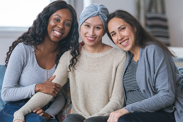 A woman with cancer getting support from her friends