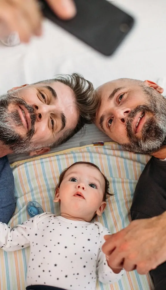 A gay couple with their adopted baby