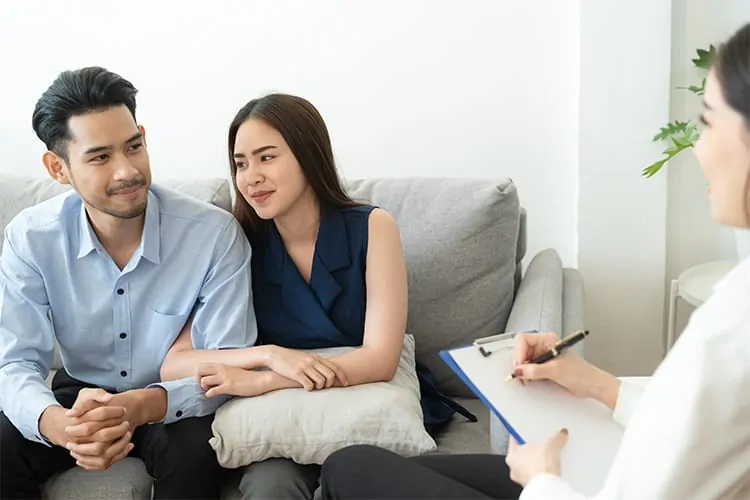 A couple talking to a doctor about reversing sterilization