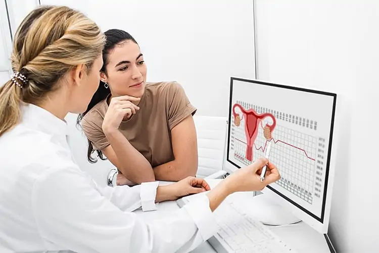 Nurse showing diagram of female hormone levels on a screen